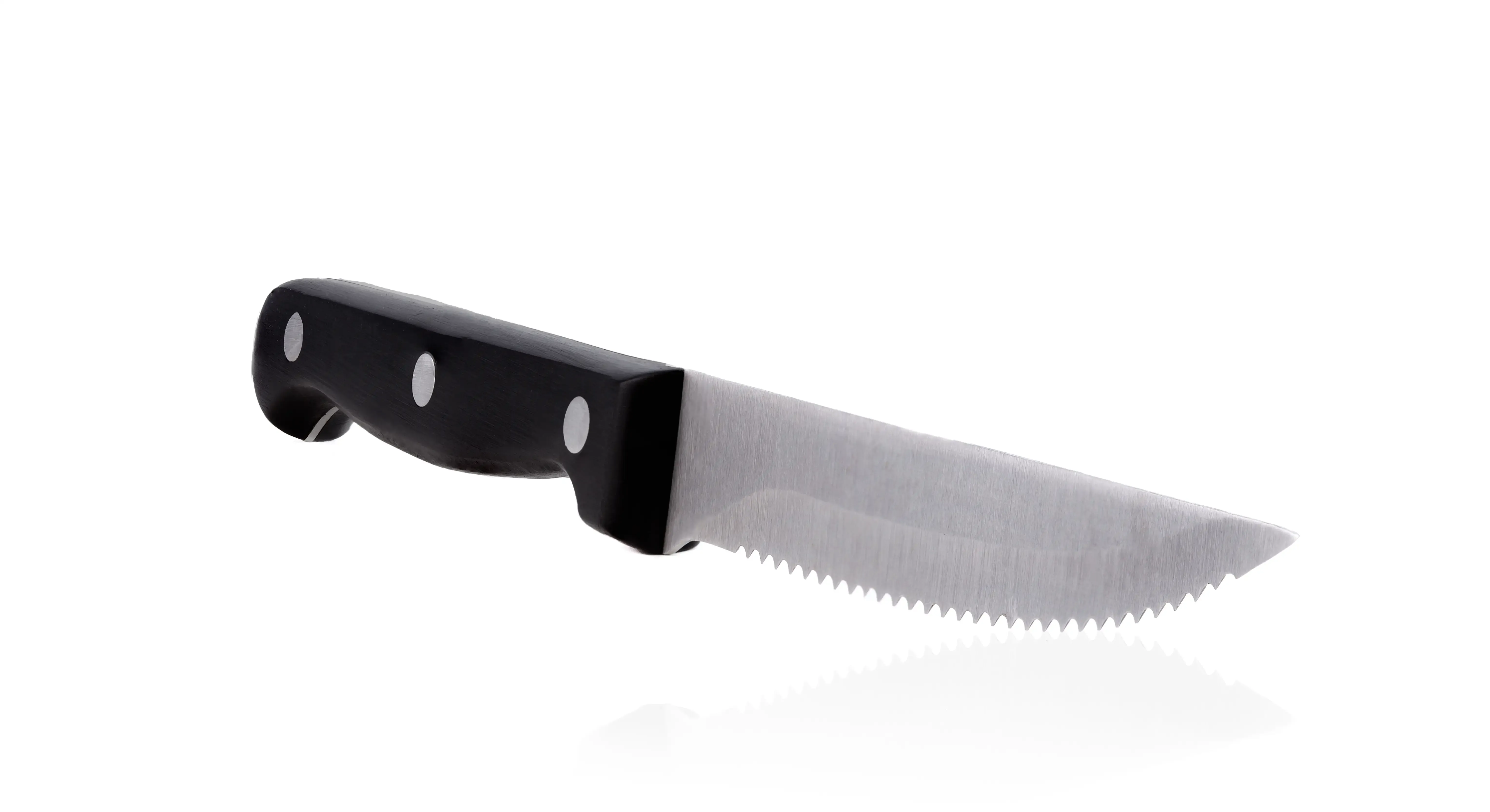A serrated knife a with black handle on a white background.