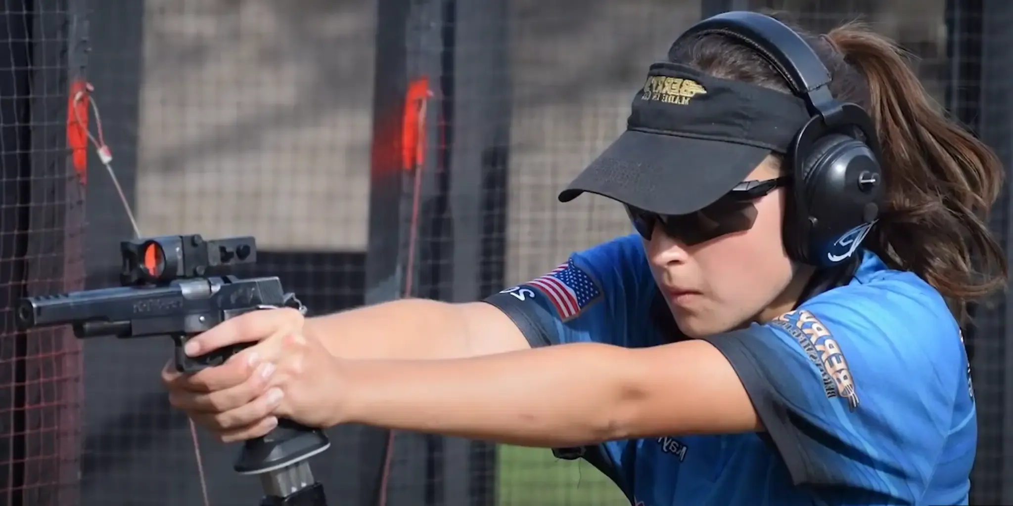 A focused female competitive shooter A focused female competitive shooter