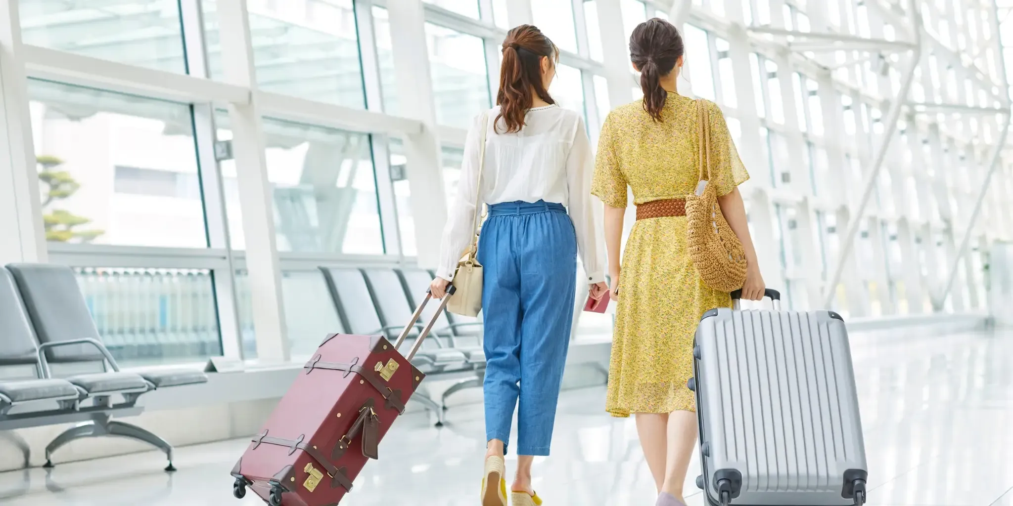 Travellers walk through an airport terminal