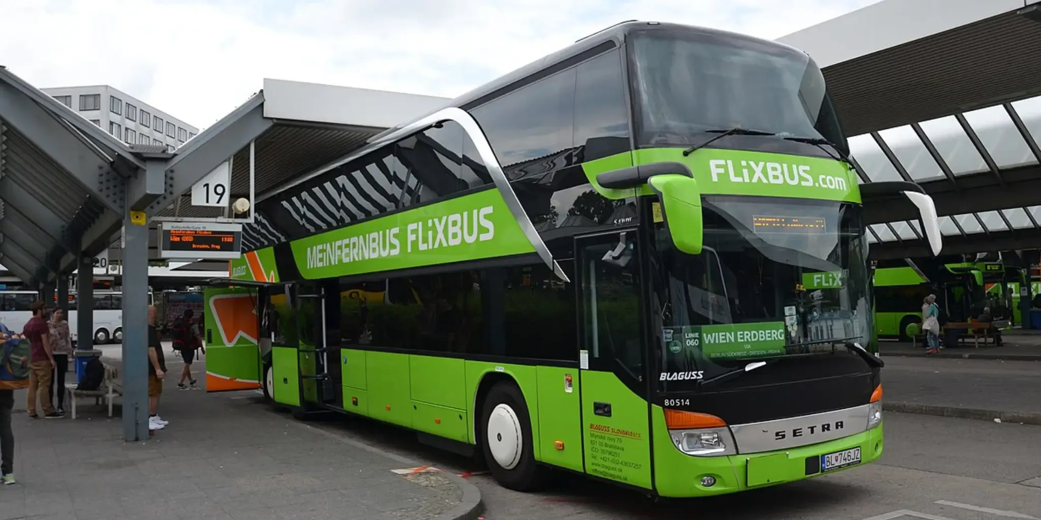A FlixBus double-decker bus at a bus stop.