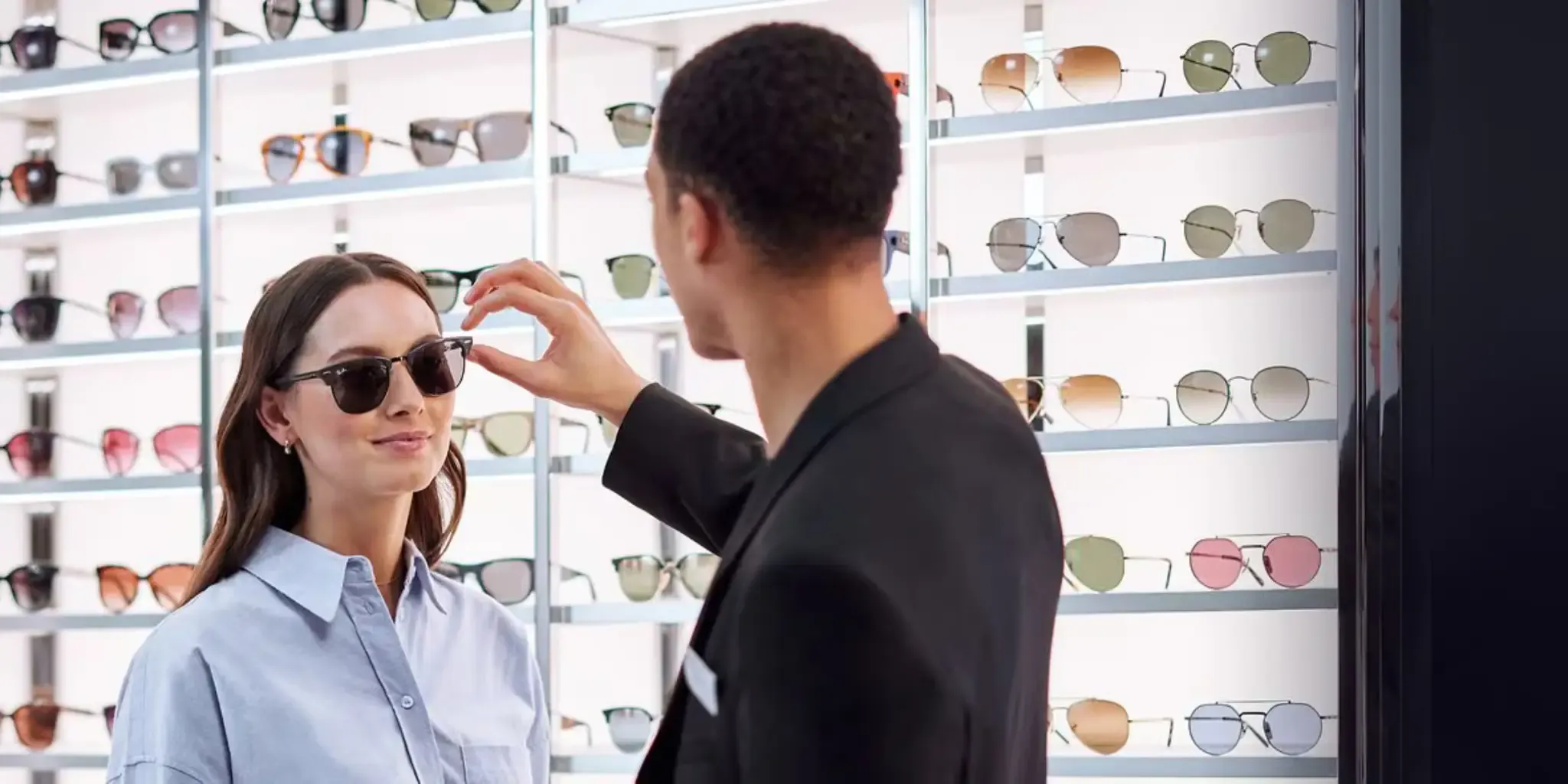 Trying on sunglasses in a Sunglass Hut store.