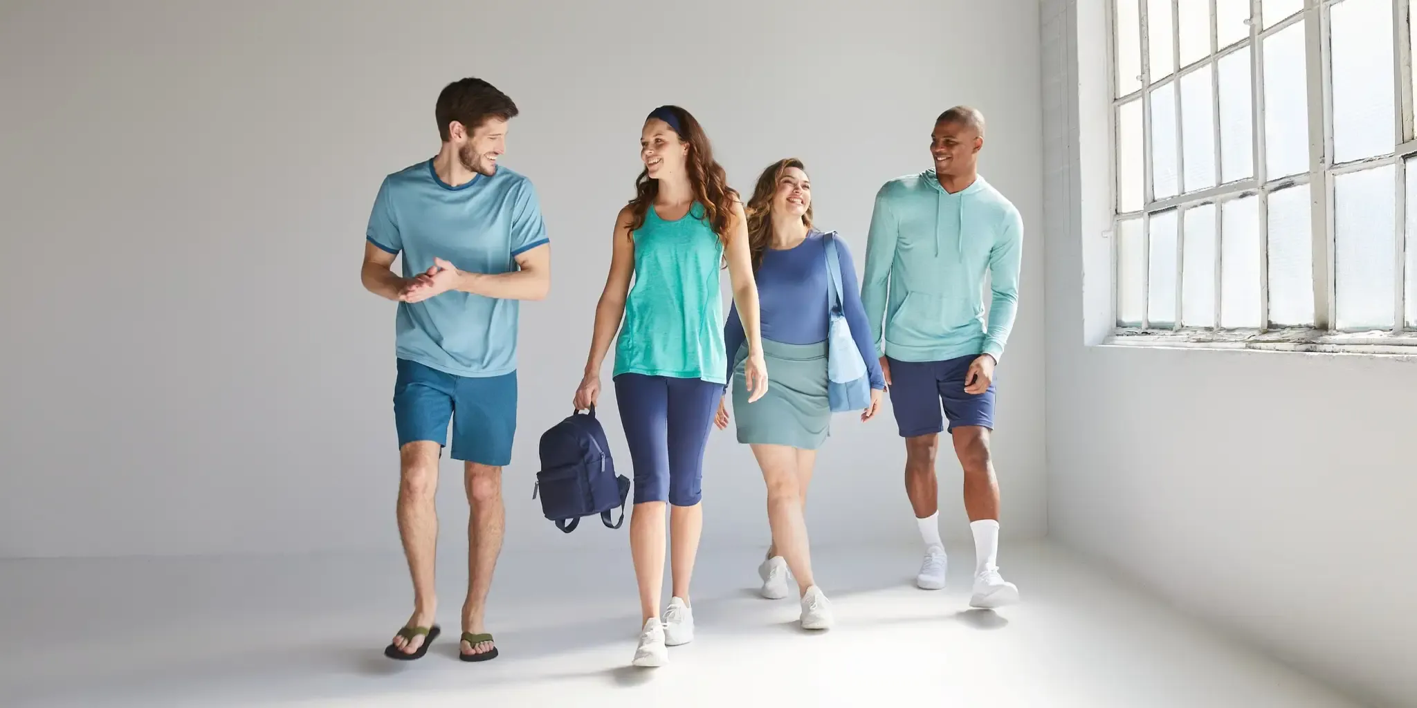 Four people wearing comfortable athletic clothing from 32 Degrees.
