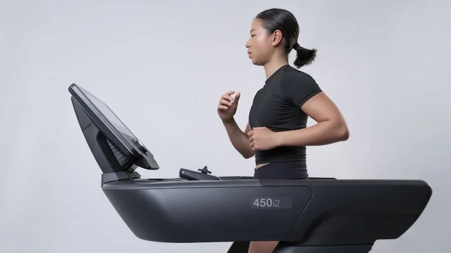 Athletic person running on treadmill during intense cardio workout session indoors