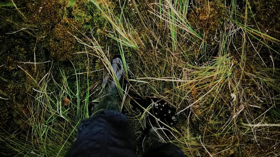 Close-up of hiking boot sole gripping muddy trail during outdoor hike