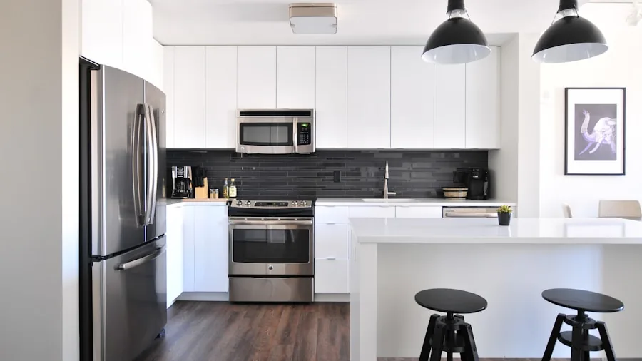 Contemporary kitchen interior featuring stainless steel refrigerator in clean, bright home setting
