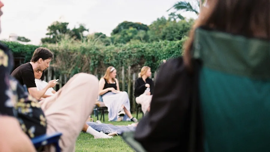 Friends enjoying outdoor entertainment together in a backyard evening setting