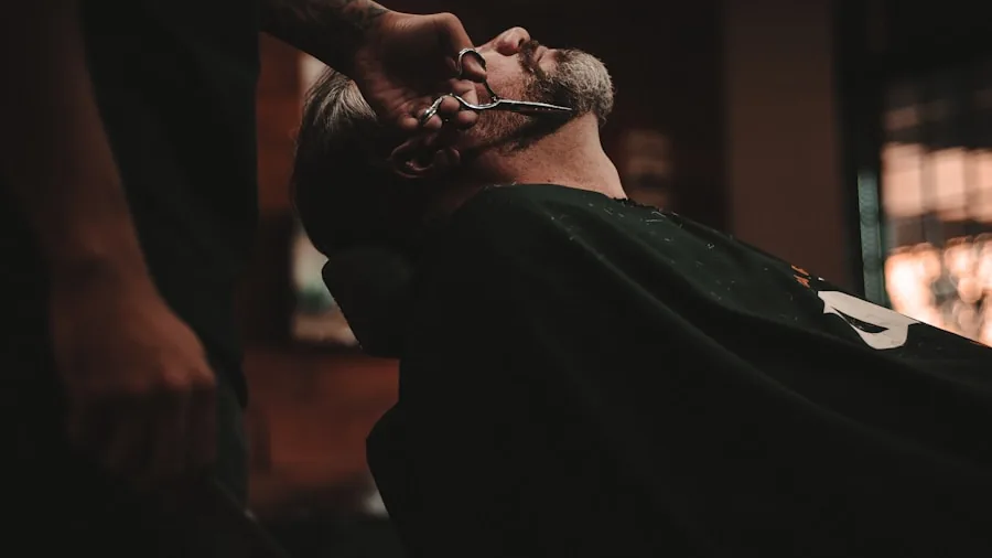 Man carefully trimming and grooming his facial hair and sideburns in bathroom mirror