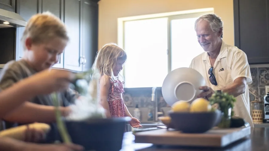 Modern kitchen with natural light, family discussing home energy efficiency and utility costs