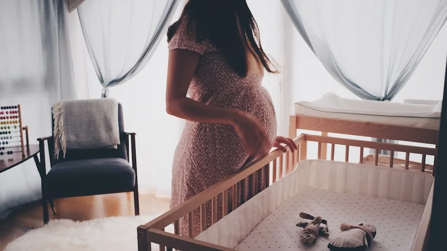 Parent watching baby monitor while baby sleeps in crib during nighttime