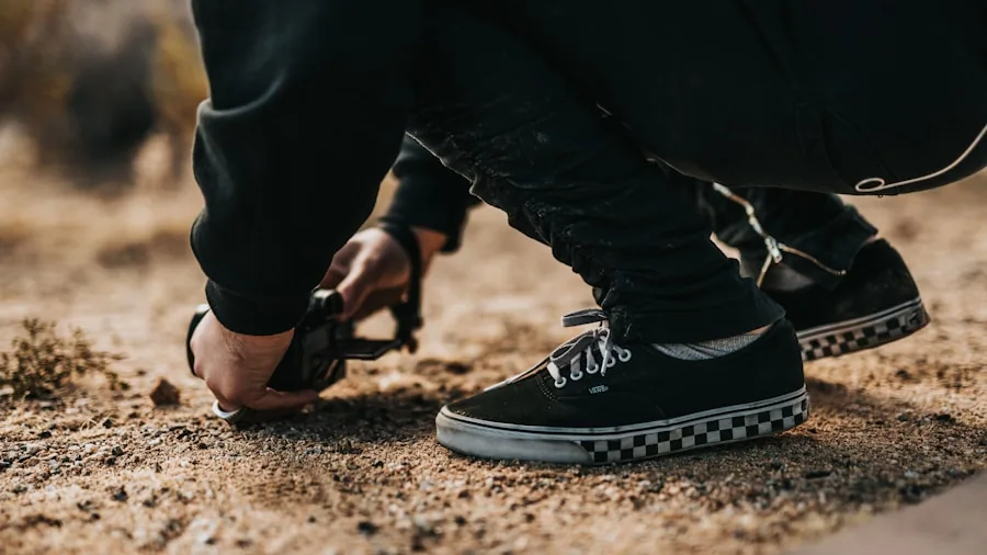 Person adjusting lace-up shoe before walk on outdoor path