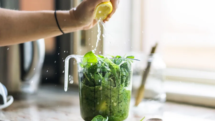 Person blending fresh fruit smoothie with ice in bright kitchen