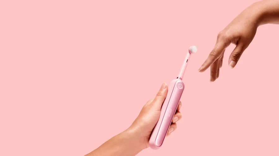 Person browsing dental care products on store shelf, examining options for oral hygiene purchases