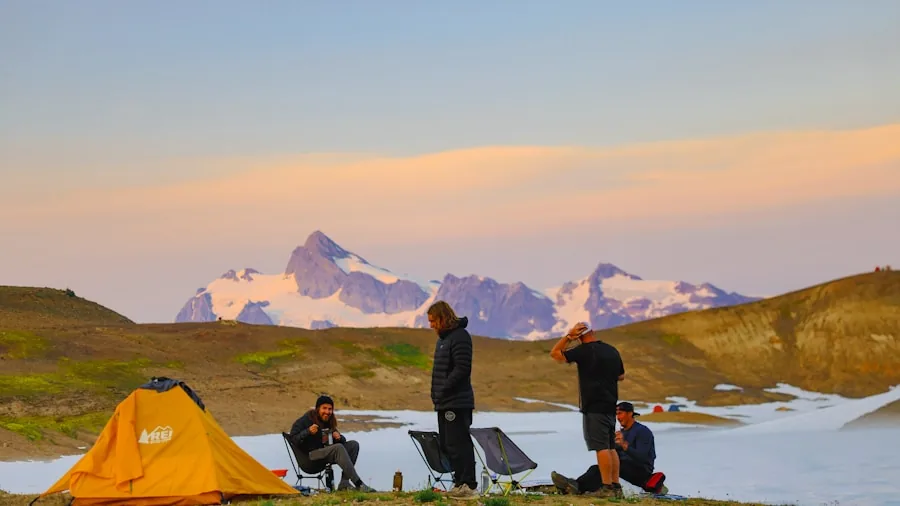 Person camping in tent checking device battery levels during outdoor adventure