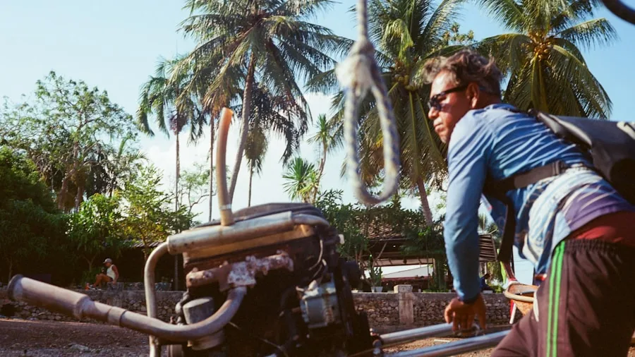 Person carefully moving heavy portable equipment across outdoor terrain with proper lifting technique