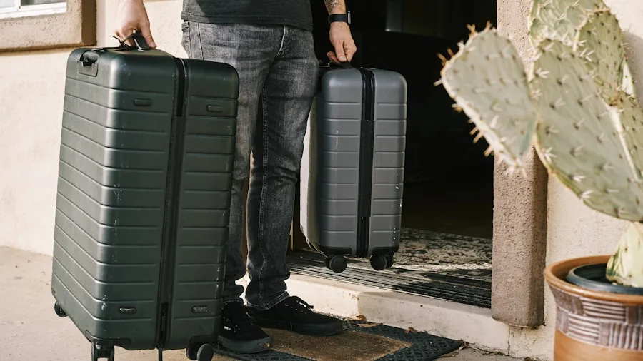 Person carefully packing clothes into a hard-shell suitcase for a trip