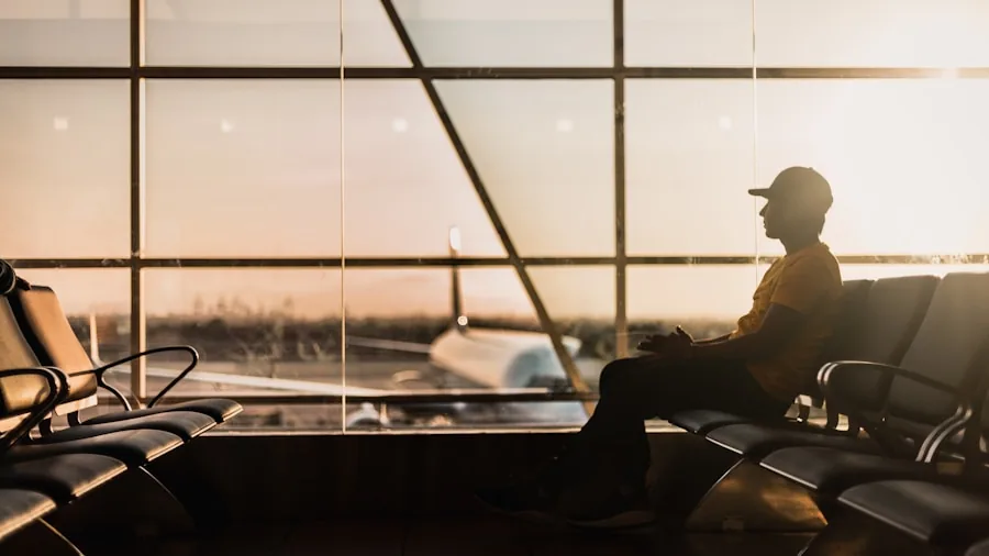 Person charging smartphone at airport gate while waiting for flight