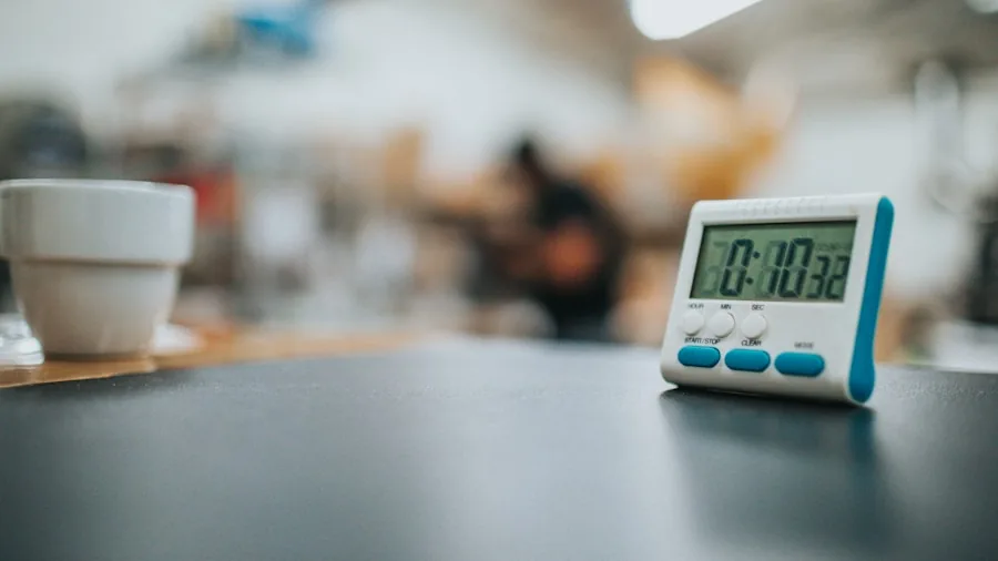 Person checking kitchen timer while preparing breakfast in modern kitchen