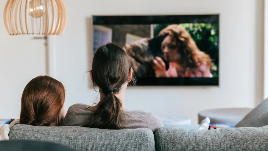 Person enjoying a TV show in a modern living room with comfortable seating