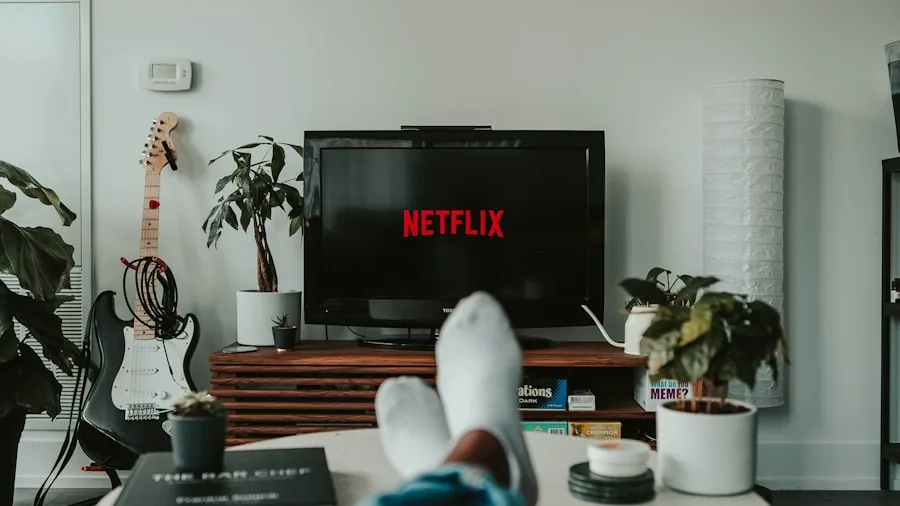 Person enjoying movie night with projector setup in living room, relaxed home entertainment experience