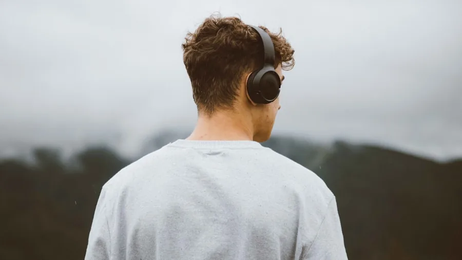 Person enjoying wireless earbuds outdoors with natural lighting and blurred background