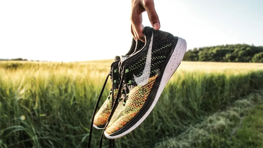 Person examining running shoes while comparing prices and value options