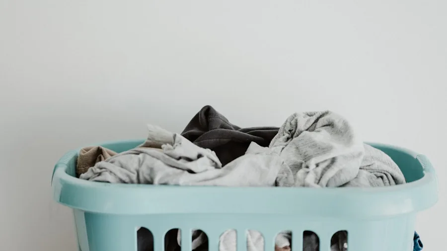 Person folding fresh white laundry in bright home laundry room with natural light