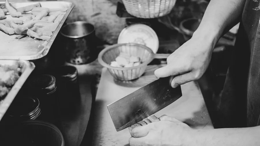 Person gripping knife handle while preparing food in kitchen, demonstrating proper ergonomic grip and control