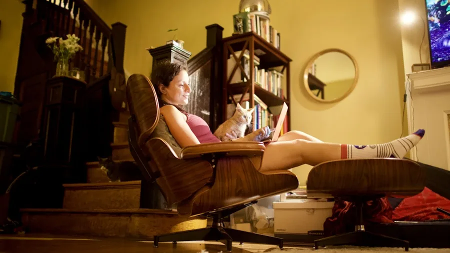 Person in comfortable reclining chair taking a relaxation break while gaming setup visible in background