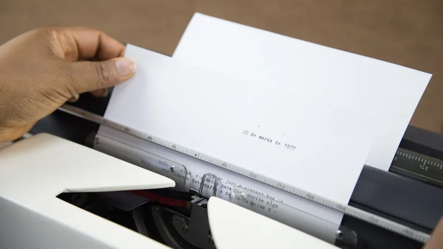 Person manually inserting papers into a shredder at a home office desk