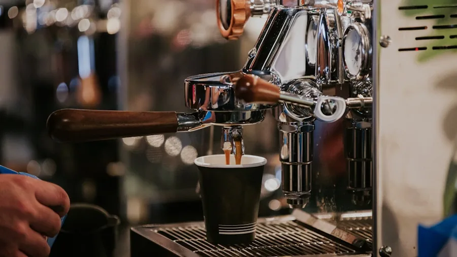 Person operating espresso machine in kitchen during morning coffee routine