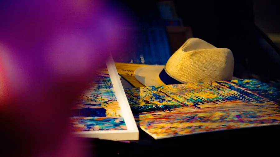 Person organizing vibrant printed photos and documents on a wooden desk with natural lighting