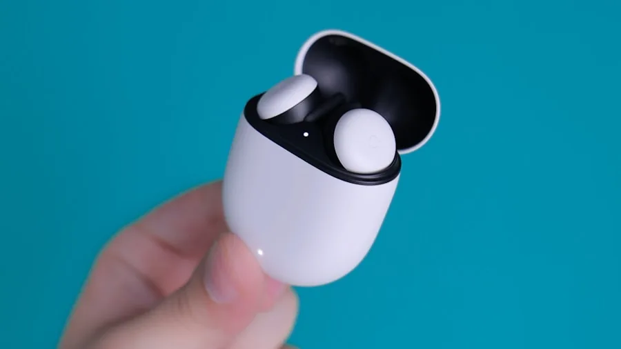 Person placing wireless earbuds in charging case during daily routine