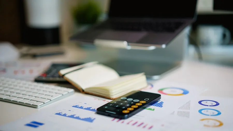 Person reviewing printer ink cartridges and paper supplies while calculating operating costs at desk
