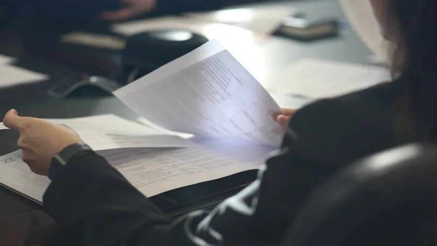 Person reviewing product warranty documentation and support materials at desk