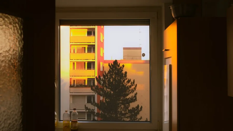 Person using blender in apartment kitchen during early morning hours