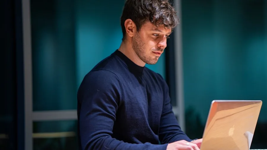 Person using laptop for work with multiple browser tabs and applications open on desk