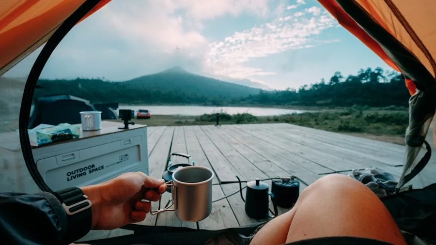 Person using laptop outdoors during camping trip, representing sensitive electronics that need power protection