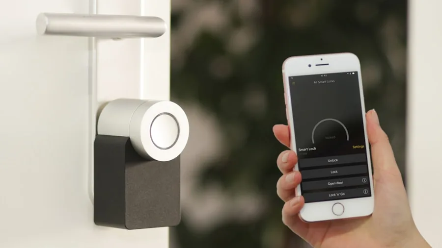 Person using voice assistant on smartphone to control home automation system in modern living room