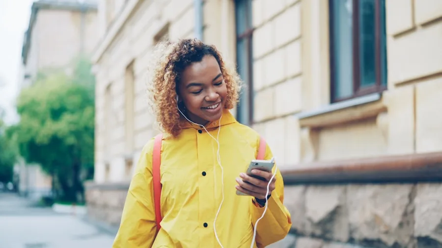 Person wearing headphones enjoying music in a natural outdoor setting, focusing on audio experience