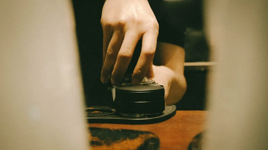 Person's hands carefully adjusting blender speed controls for precise texture consistency while preparing smoothie