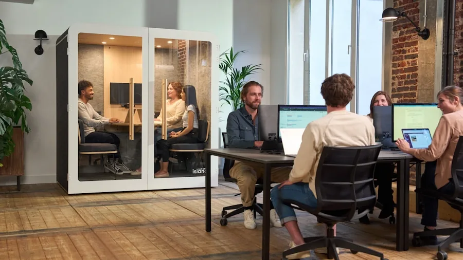 Professional focused at desk in calm open office workspace with natural light