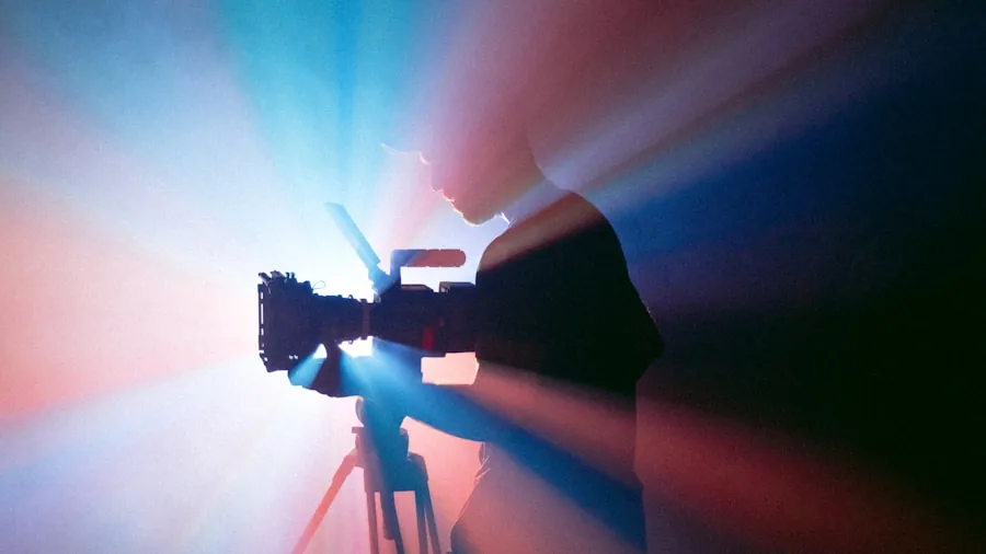 Professional videographer capturing smooth motion footage with mirrorless camera equipment in natural setting