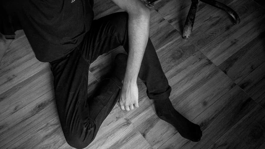 Professional woman relaxing at desk with feet elevated, demonstrating proper ergonomic posture during work break