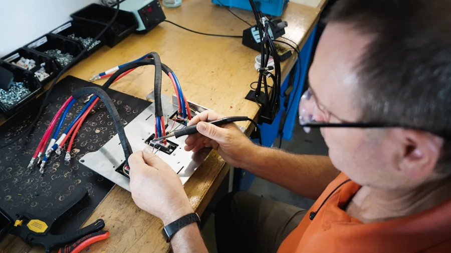 Someone plugging in various tech cables and connectors to devices on a desk