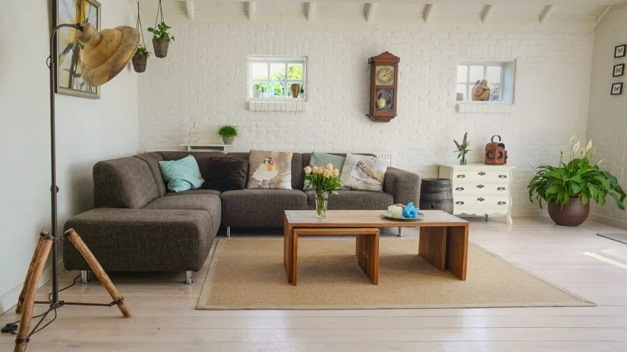 Woman vacuuming a carpeted living room in a modern home during spring cleaning